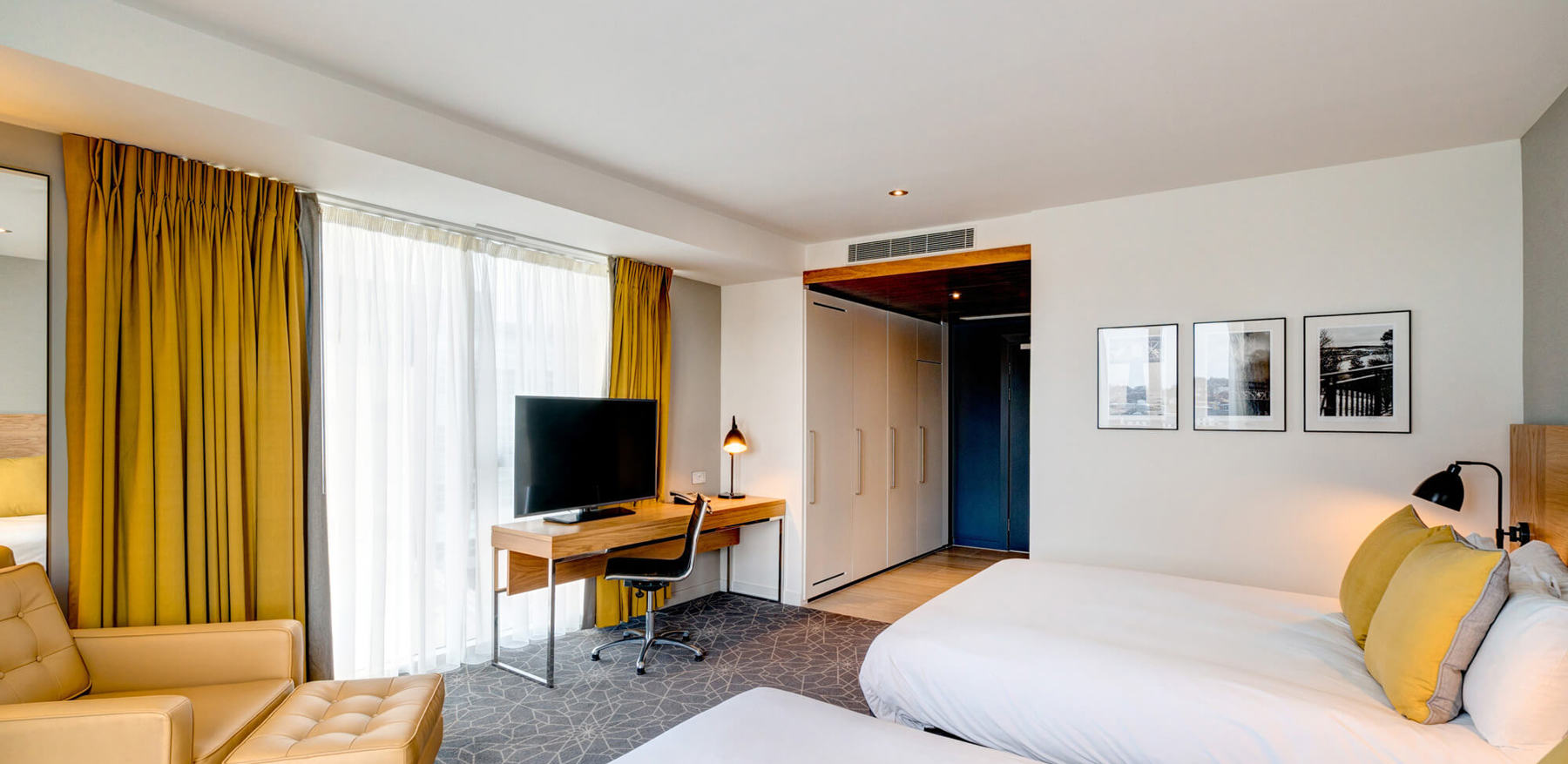 Family Room bedroom with two beds, armchair and desk