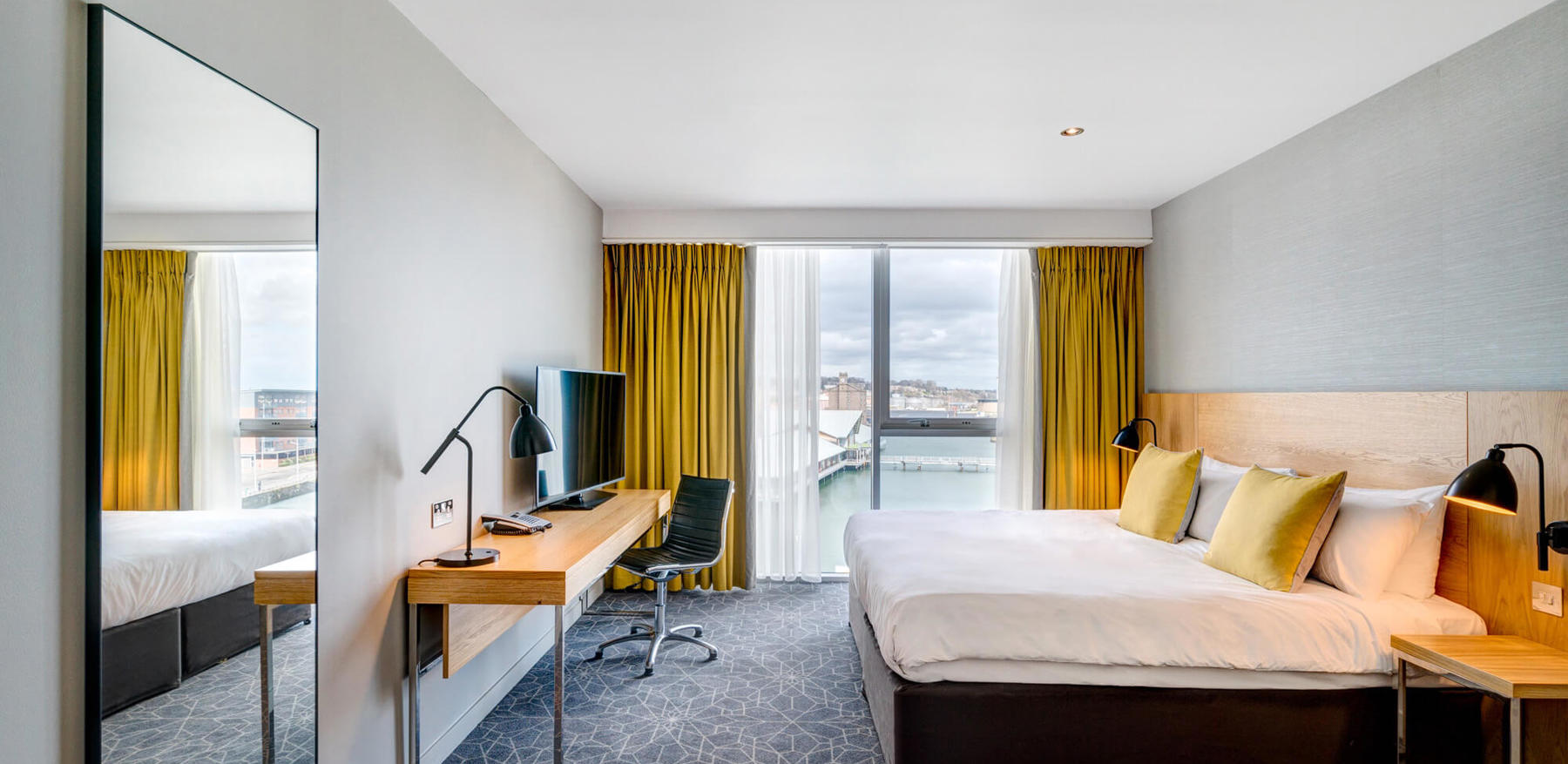King-size bed with TV on desk and Quay Views
