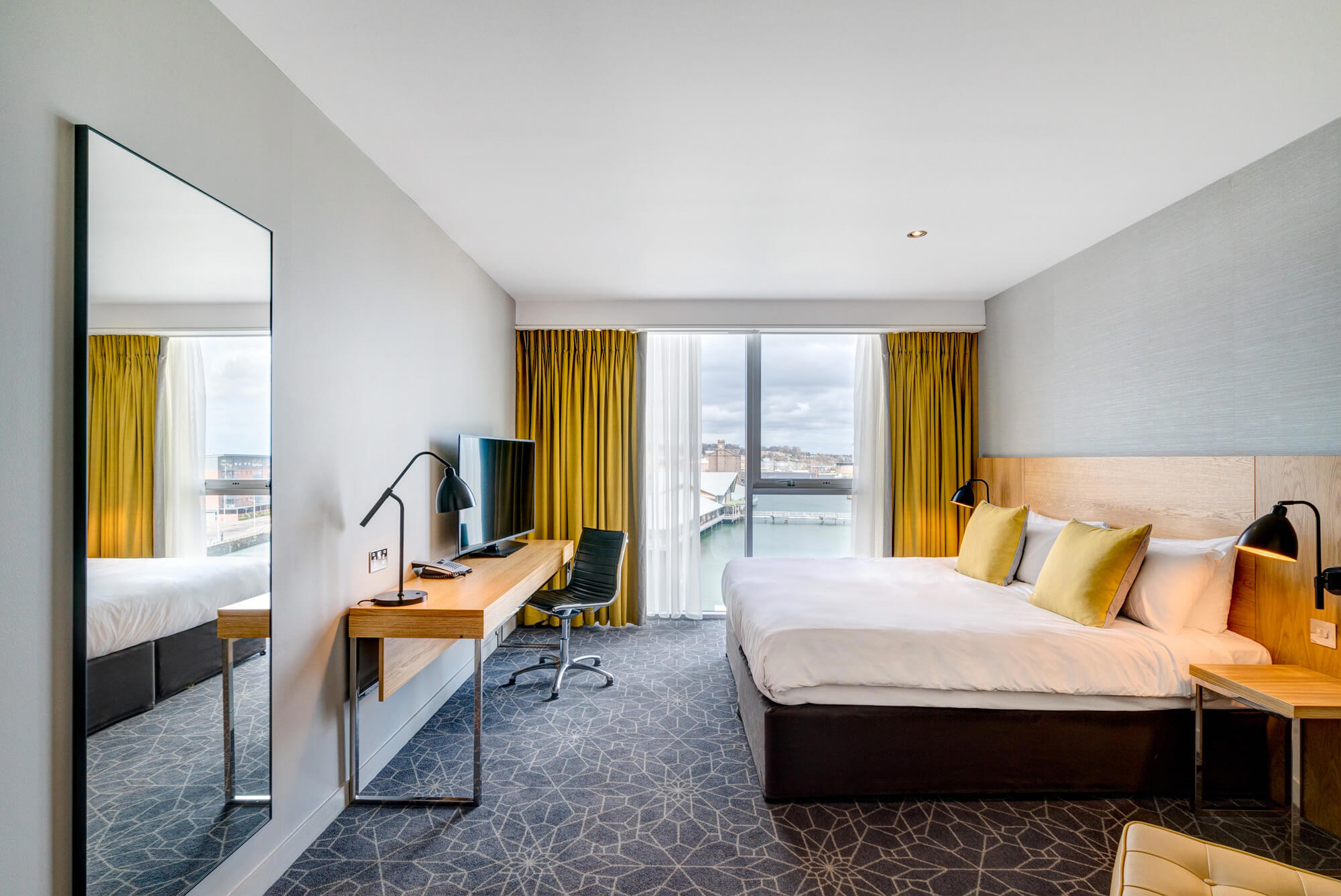 Apex City Quay Hotel Executive Double room with a King size bed, desk, TV and City Quay views