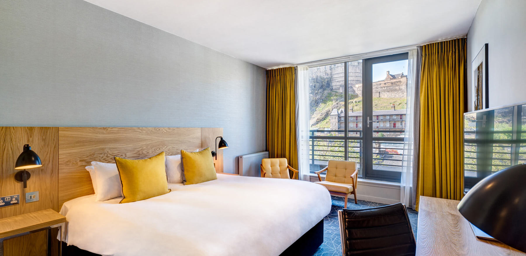 Castle View Deluxe Room with Balcony king-size bed at Apex Grassmarket Hotel