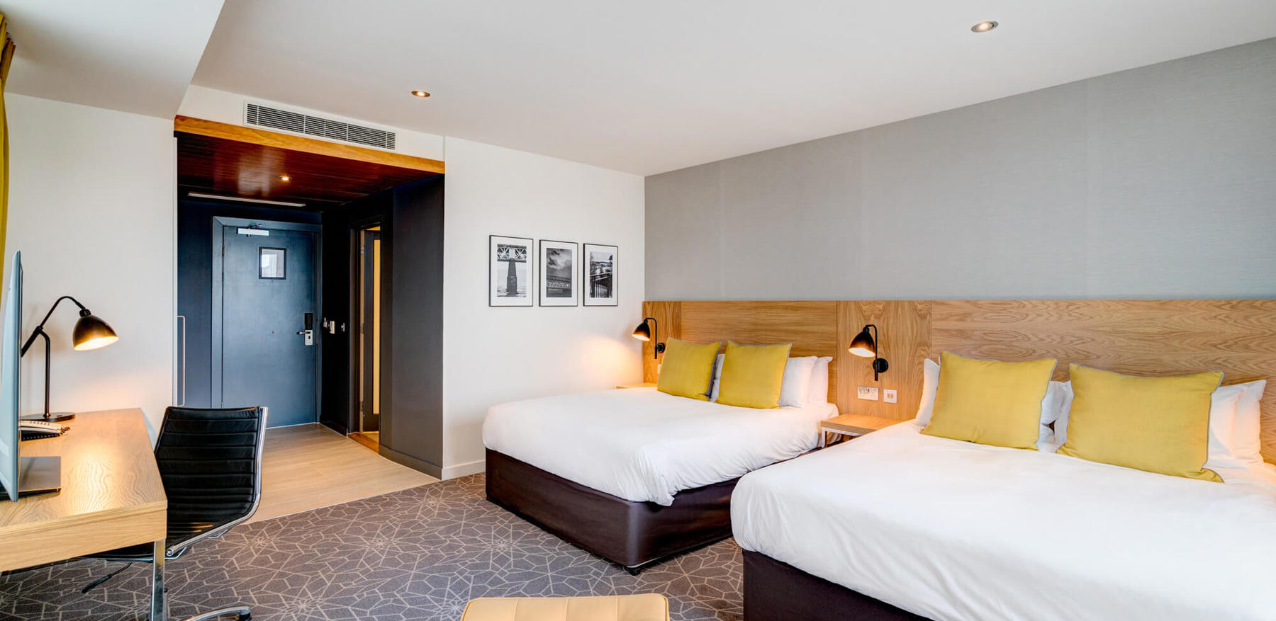 Family Room with two beds made up and desk area