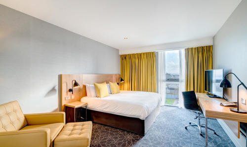Apex City Quay Hotel City Bedroom with double bed, large desk and arm chair