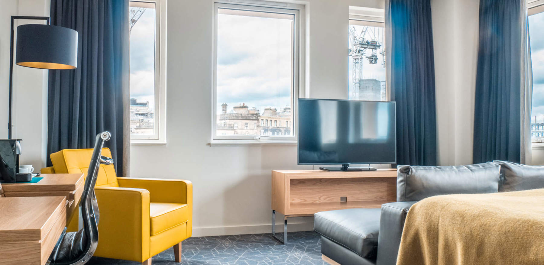 Deluxe Room with king-size bed and seating area at Apex Waterloo Place Hotel