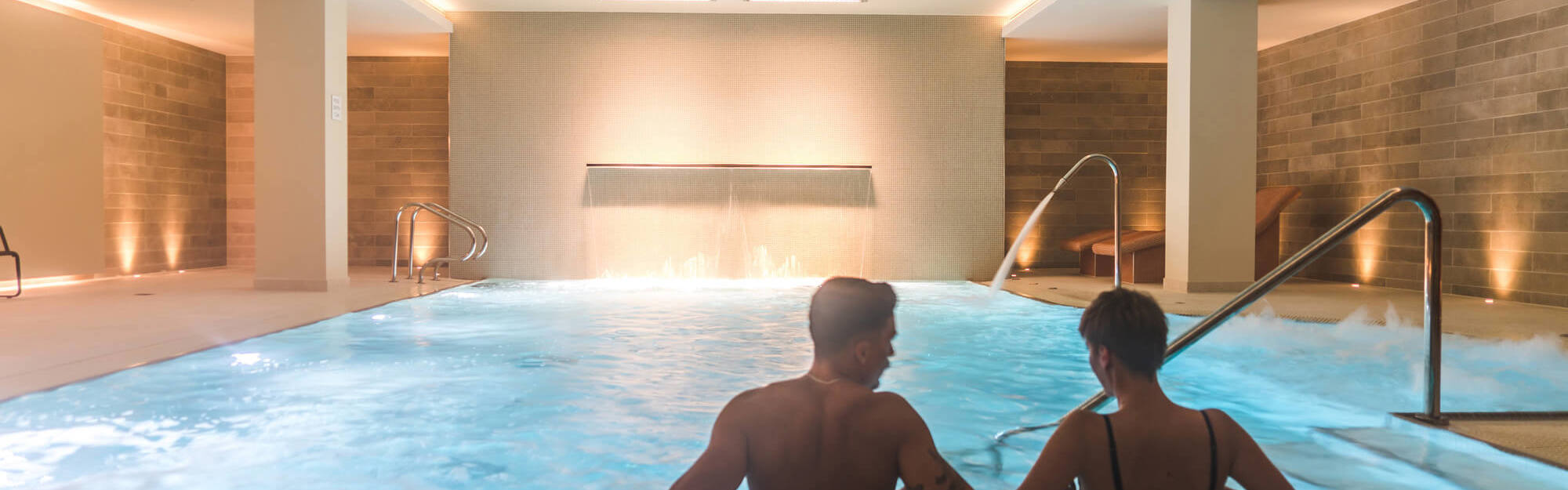 Two guests relaxing in pool at Apex City of Bath Hotel