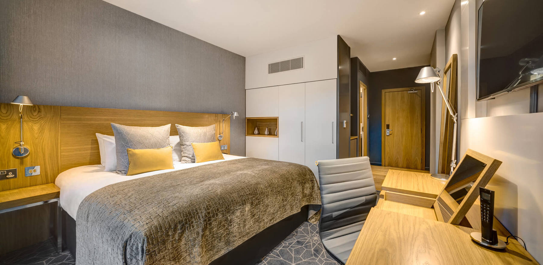 King-size bed with TV and desk area