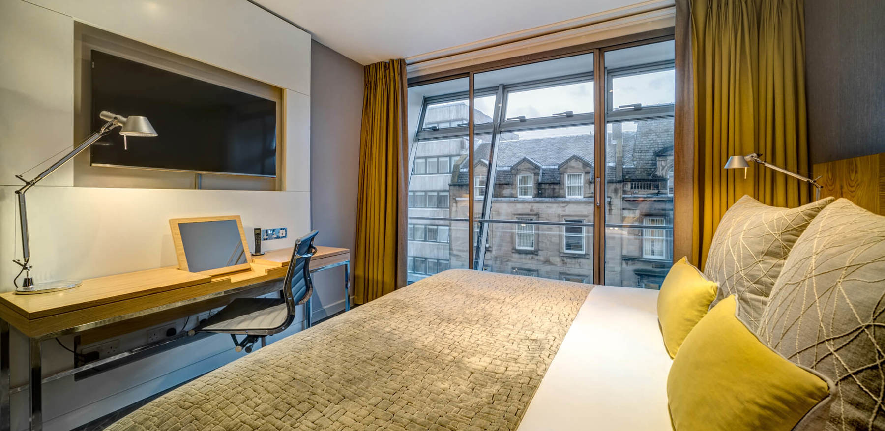 King-size bed with TV and desk area