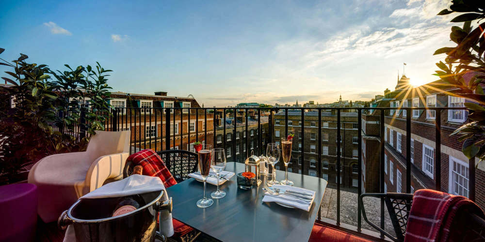 Champagne dinner set up on the balcony of a Apex Temple Court Hotel Deluxe Room