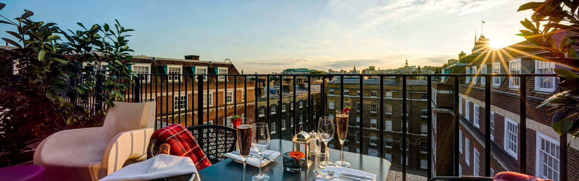Champagne dinner set up on the balcony of a Apex Temple Court Hotel Deluxe Room