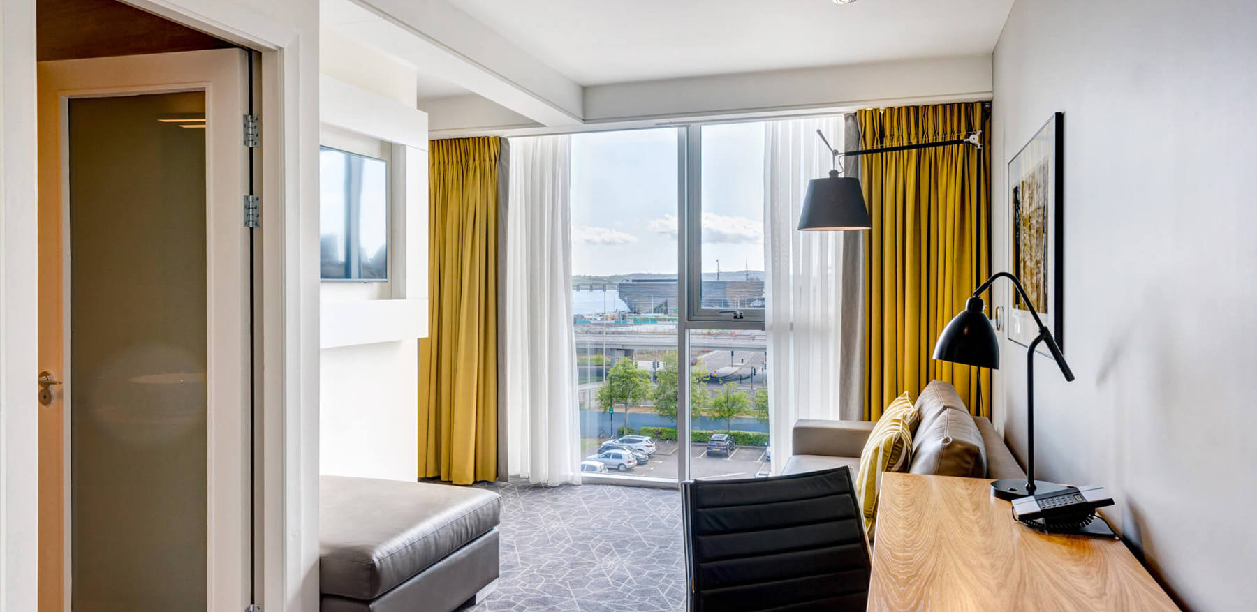 Junior Suite living area with sofa and TV