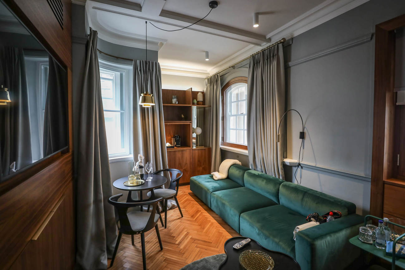 The living area of the Grand Suite at Apex Temple Court Hotel