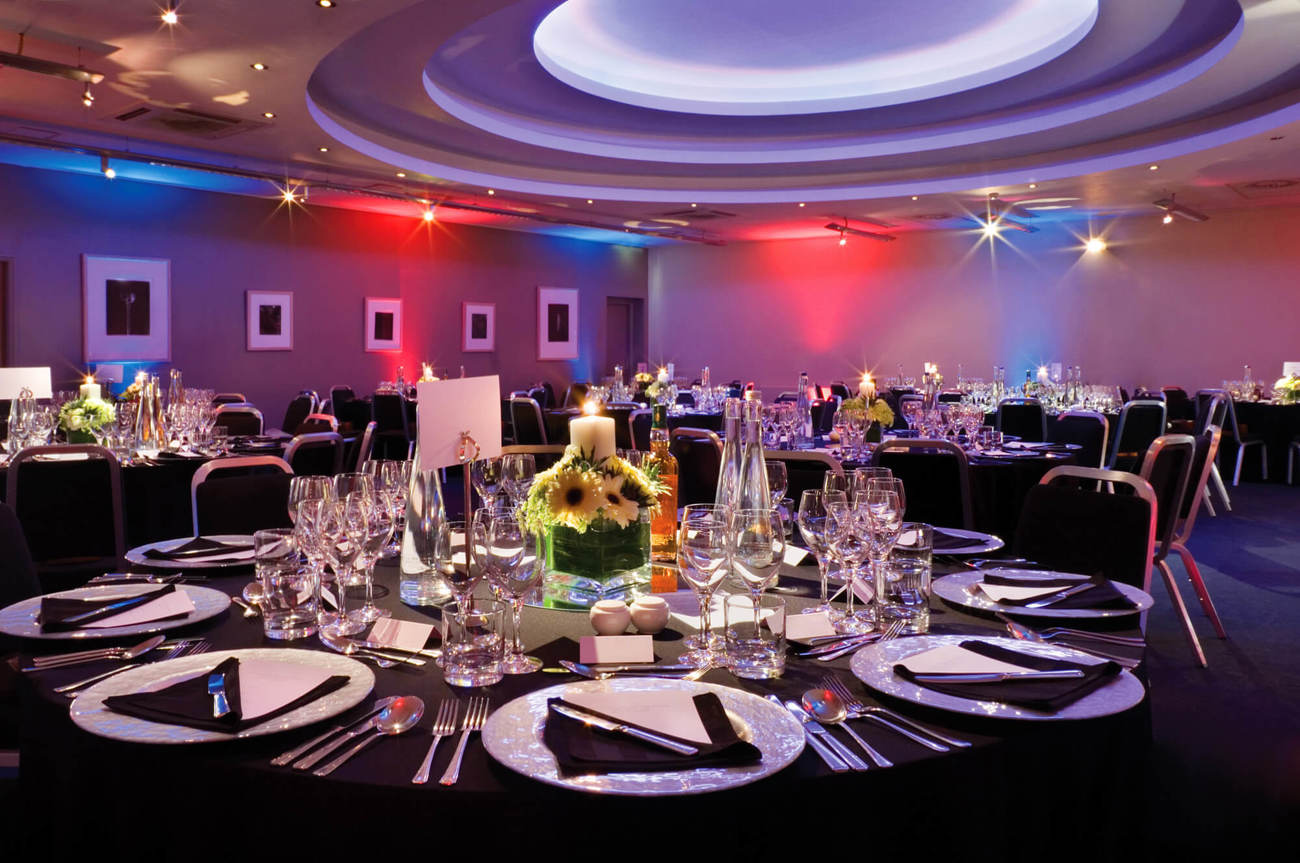 Apex Suite set up for private function with table cloths and plates on tables