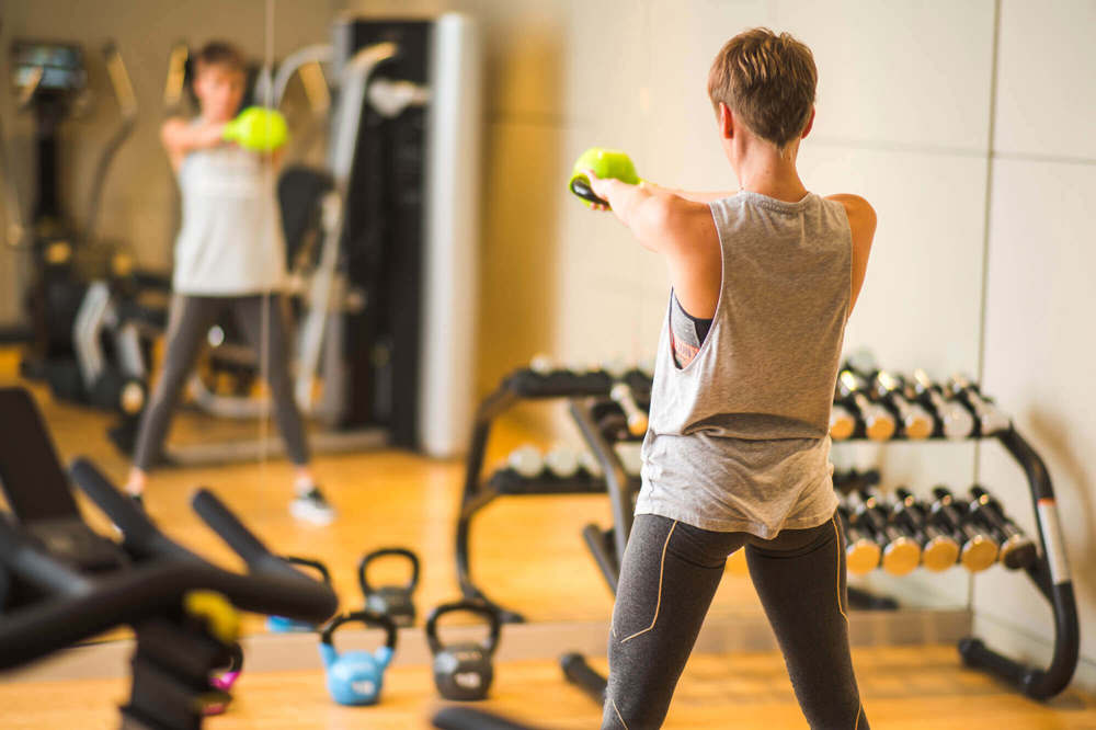 Female guest working out in 24-hour gym at Apex City of Bath Hotel