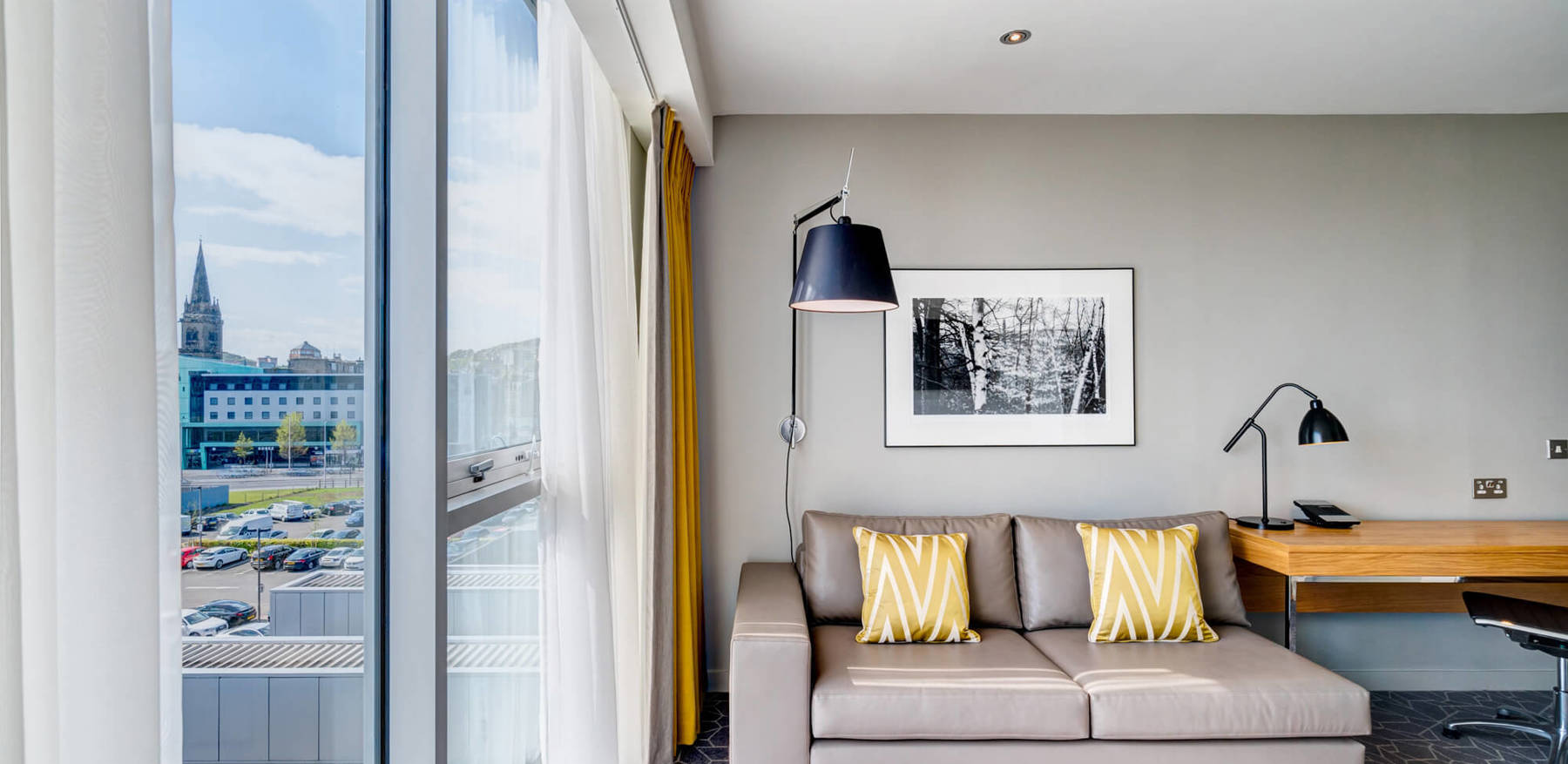 Junior Suite sofa and reading lamp next to window