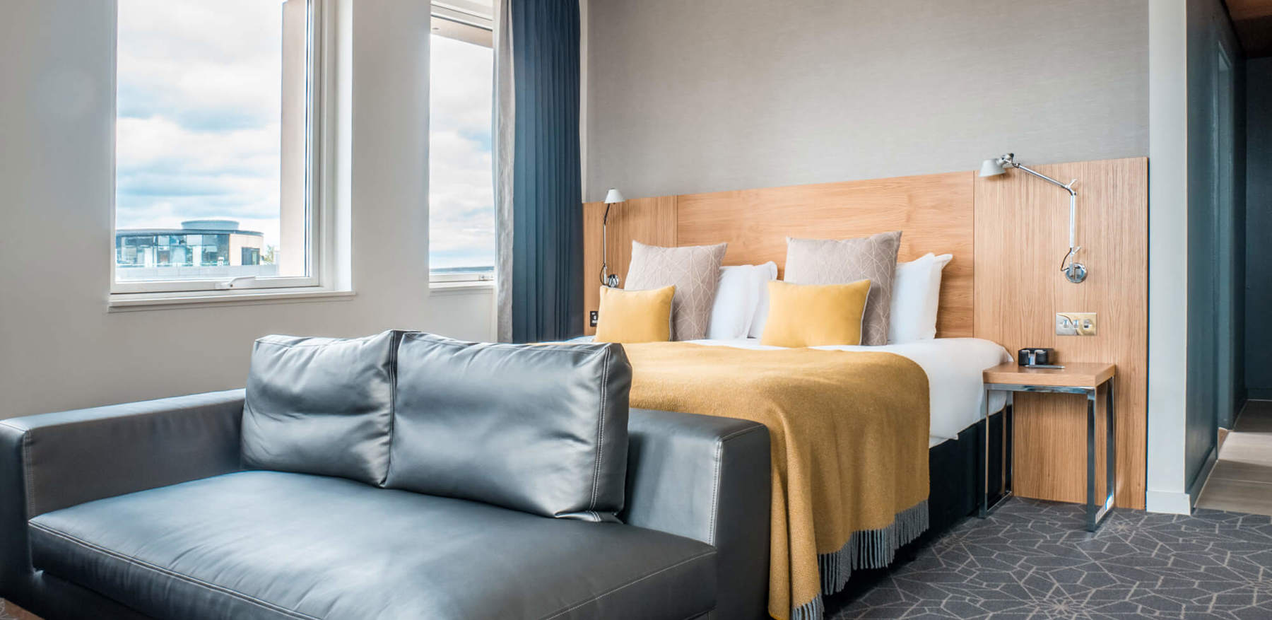 Deluxe Room with king-size bed and sofa at Apex Waterloo Place Hotel