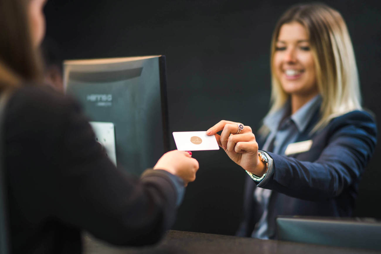 Receptionist handing over hotel room key